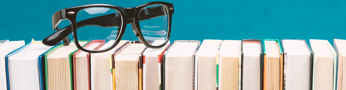 Glasses on top of books