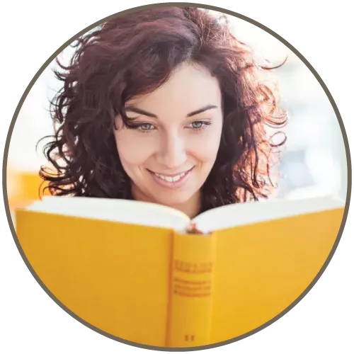 Woman smiling and reading a book