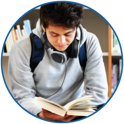 Teen with headphones reading a book