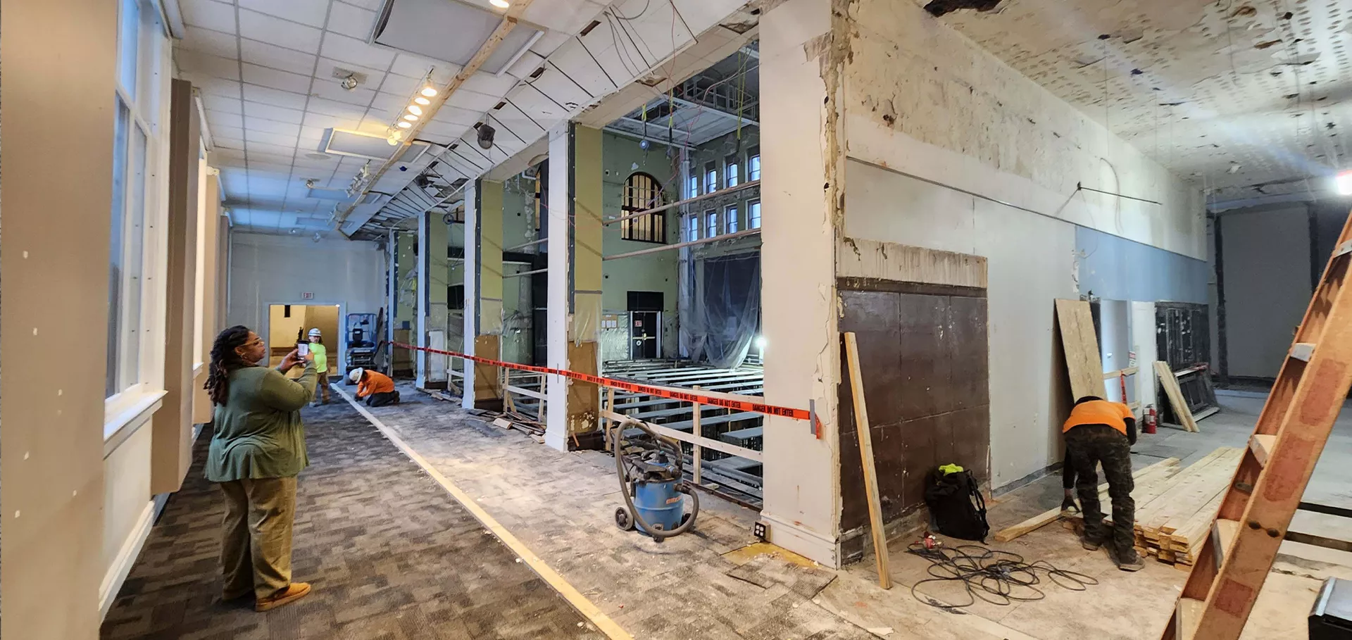 Open gallery area with construction crew