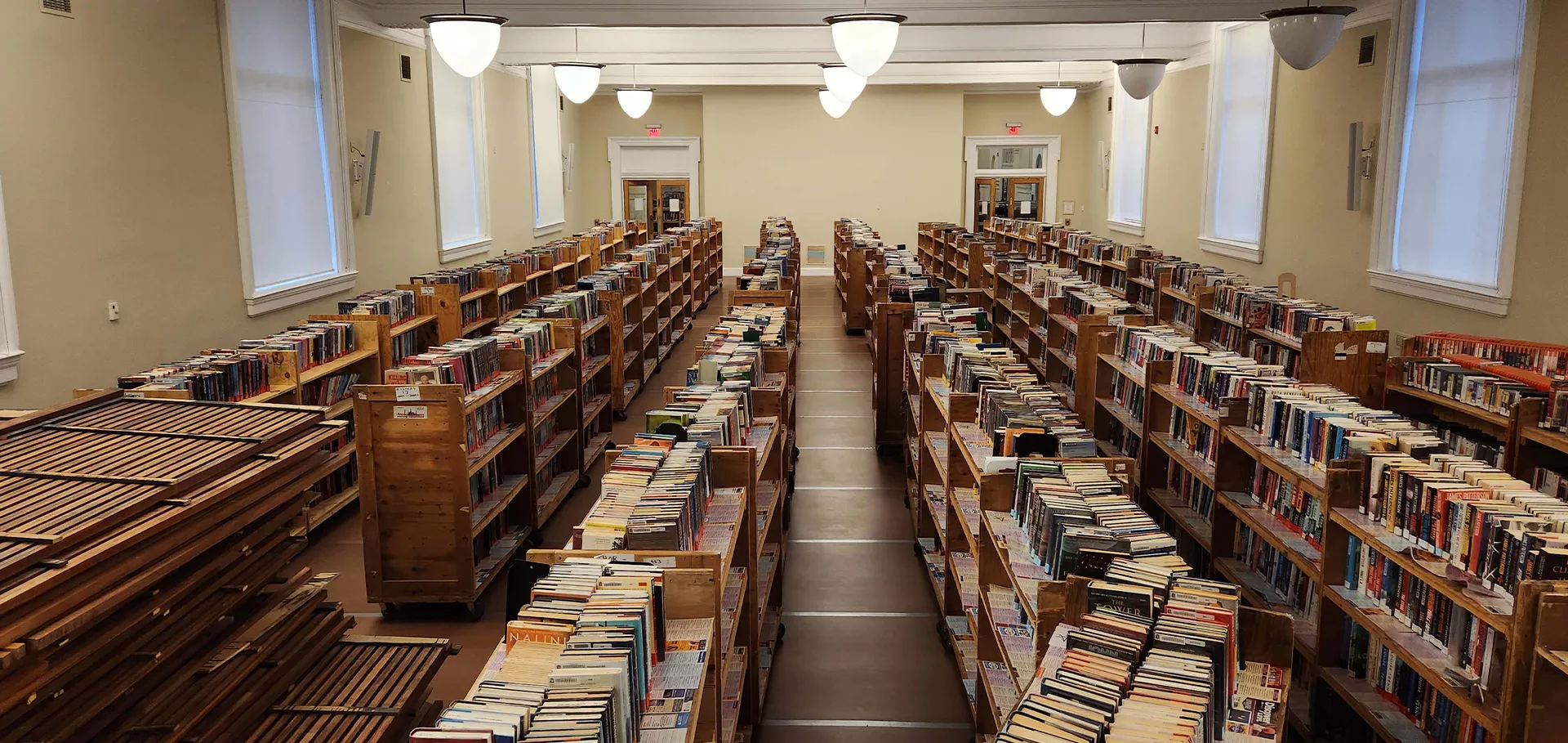 Auditorium lined with books on wooden carts