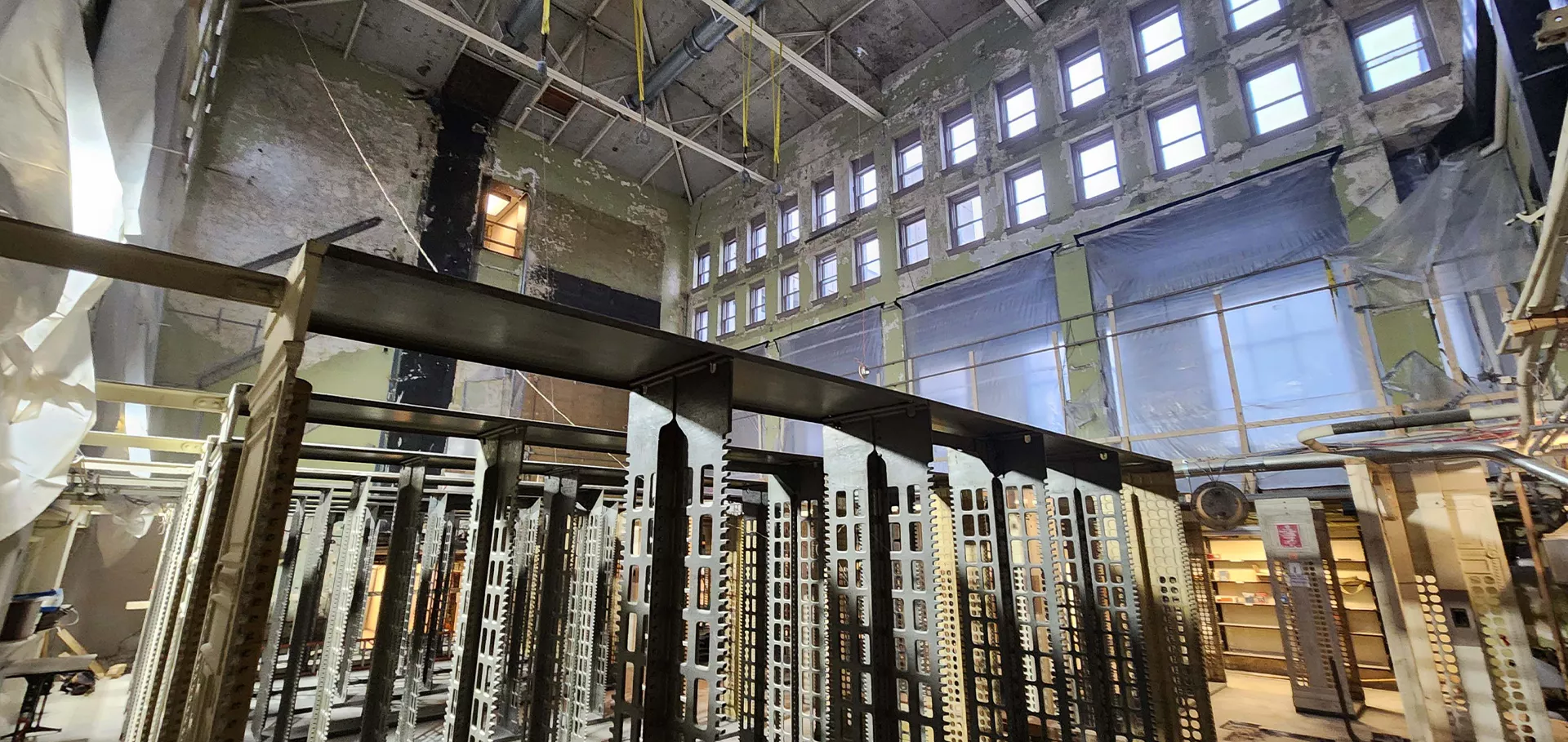 Metal shelves in the stacks area with a view of the windows