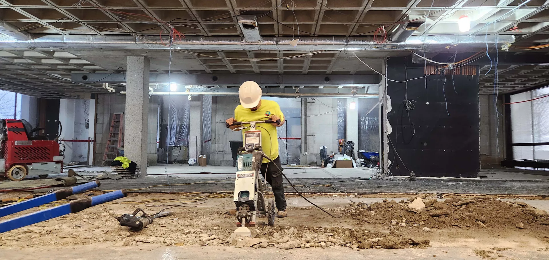 Construction workers jackhammering the floor