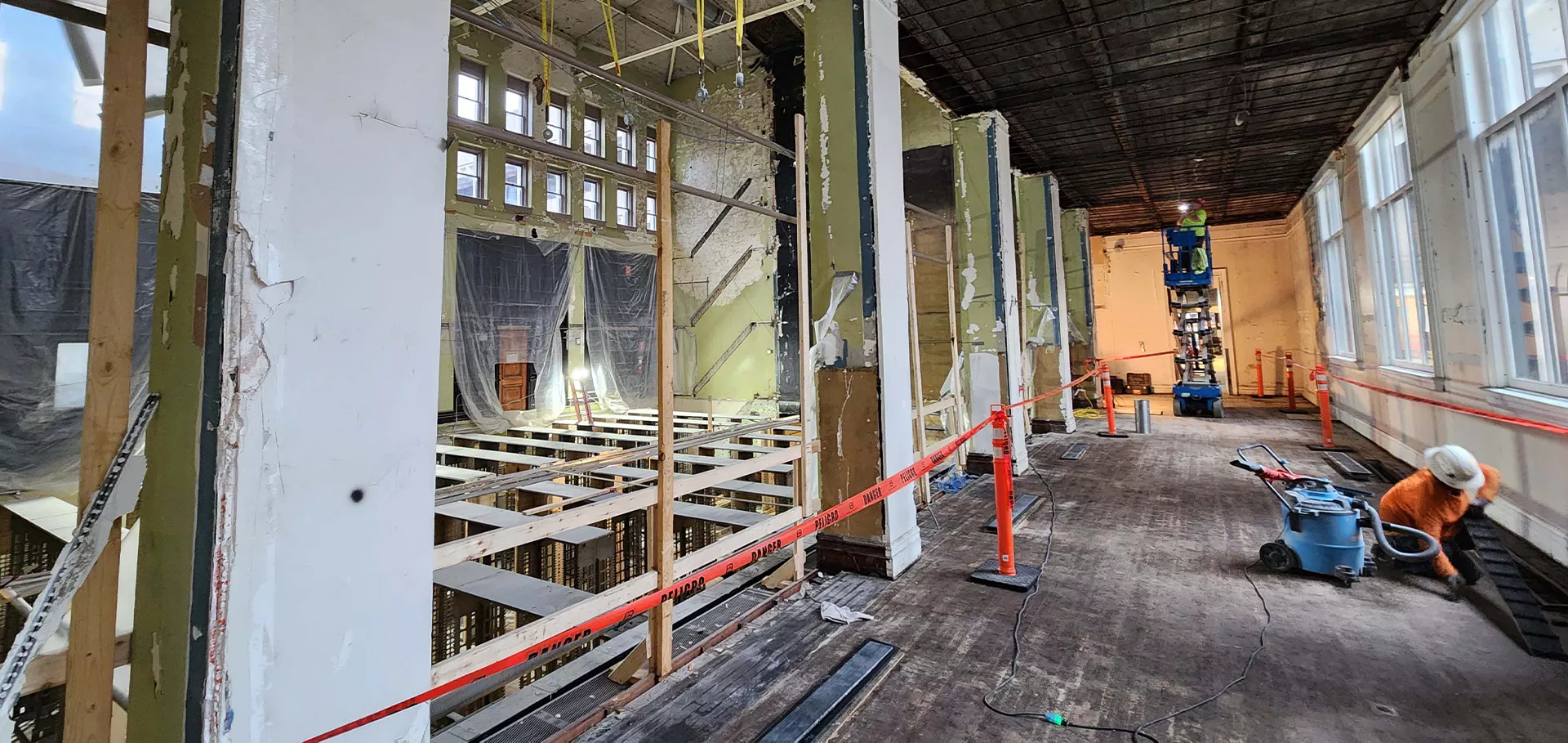 Construction workers in the Bernheim gallery working on the floor and ceiling