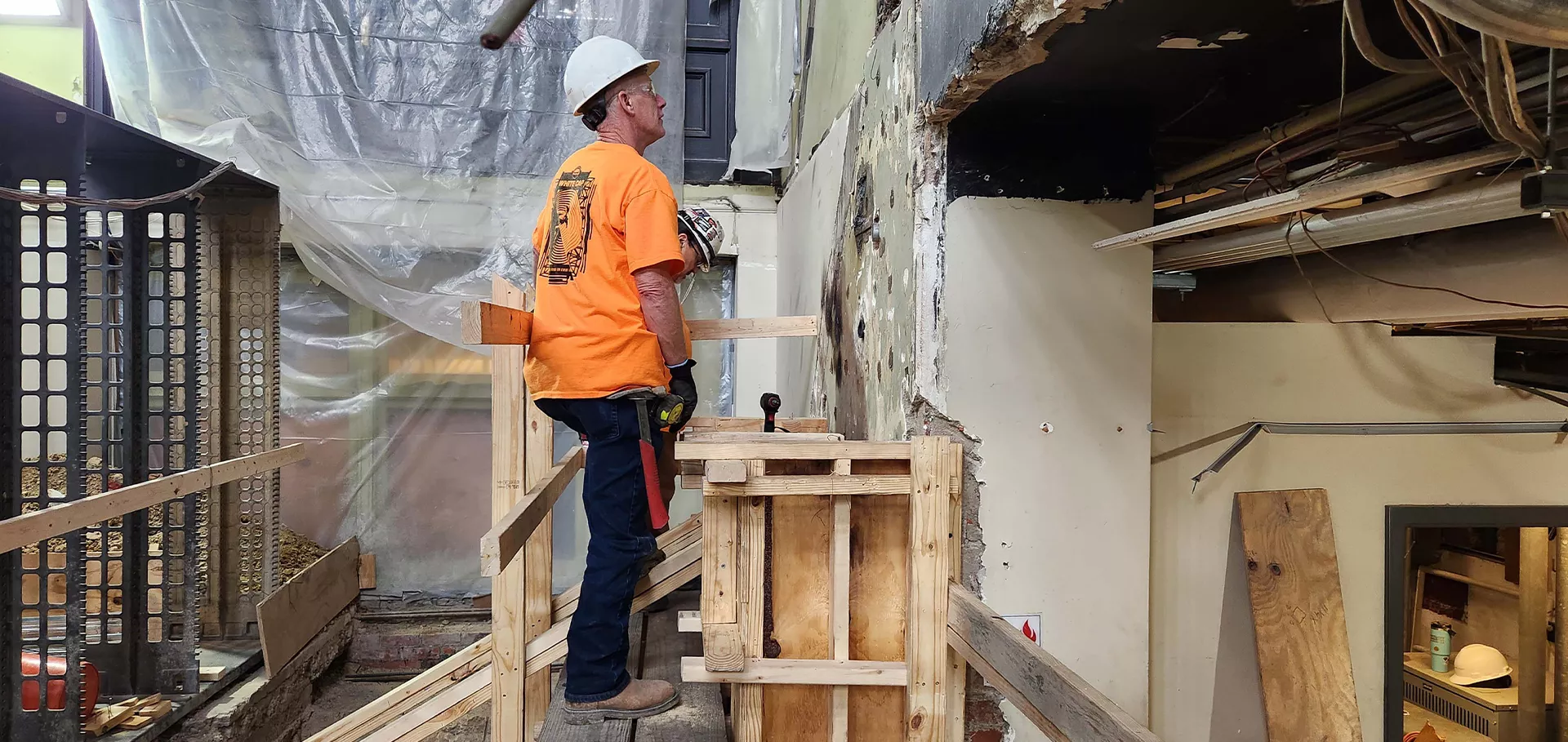Construction worker inspecting a section of the wall