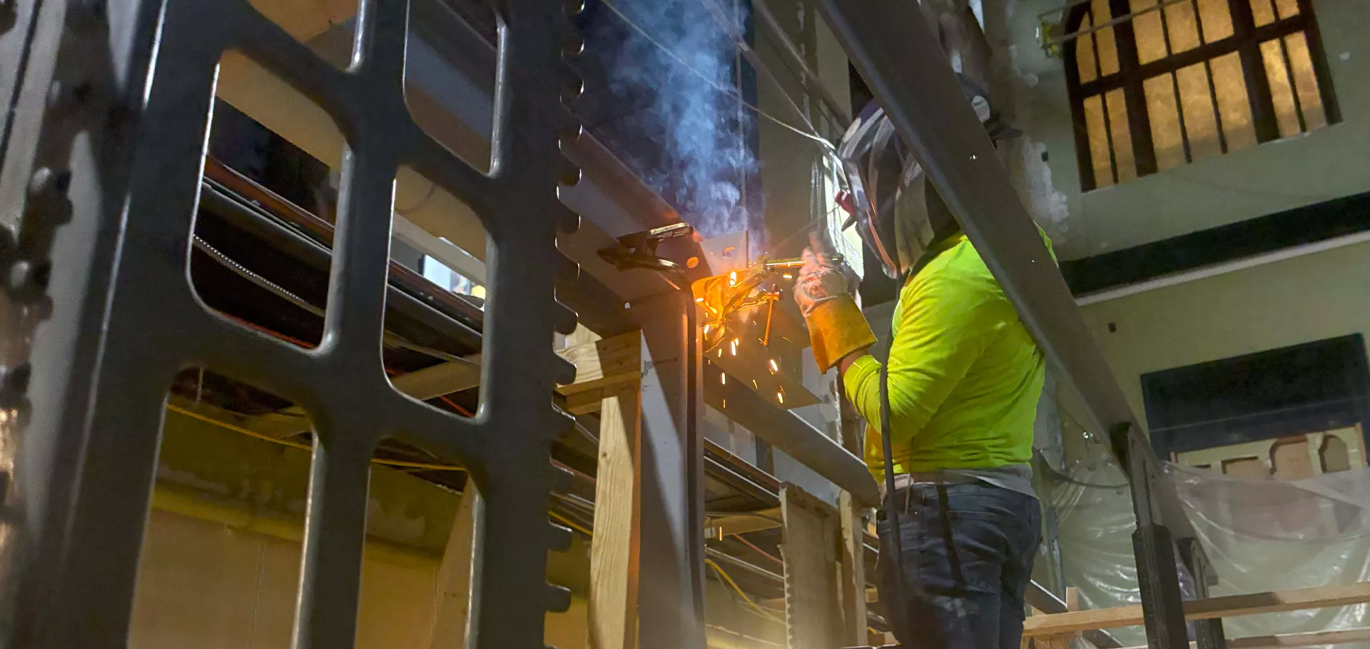 Construction worker welding steel beams