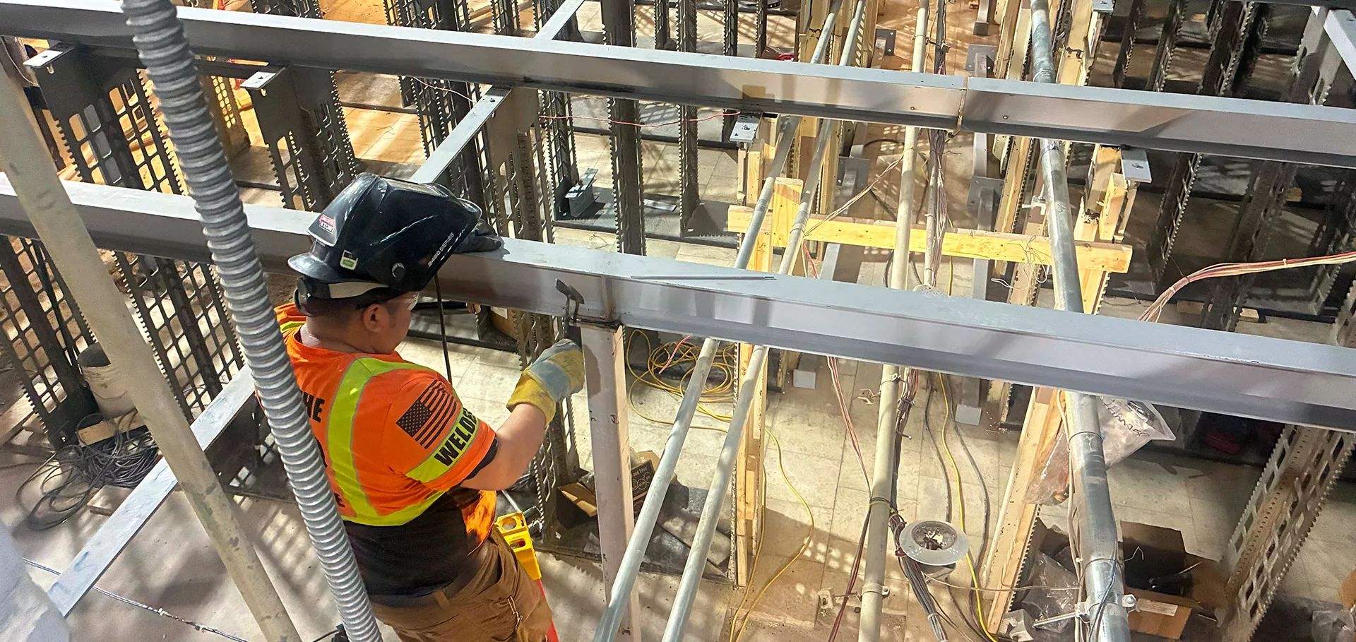 Construction worker welding steel beams