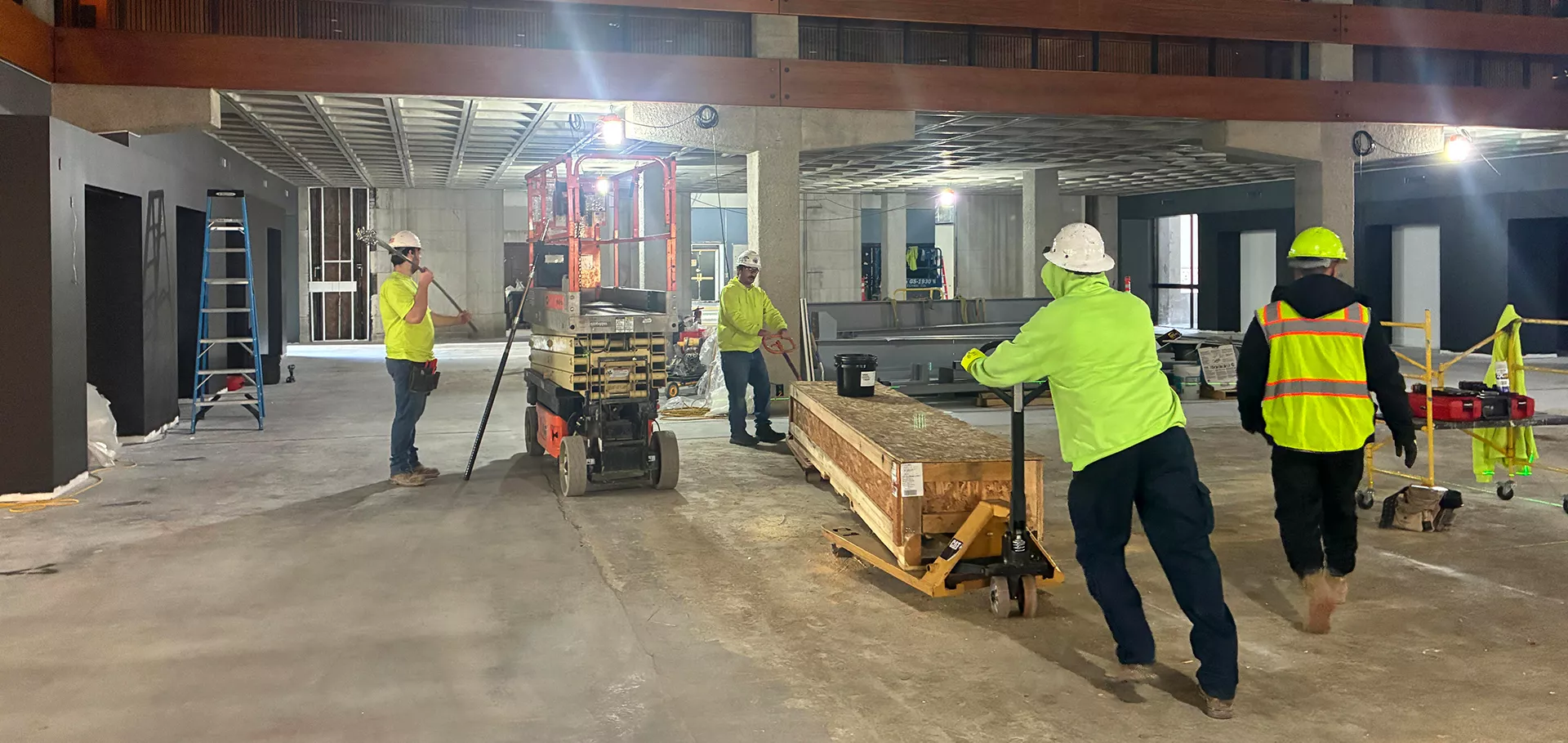 Construction workers moving materials in the North lobby