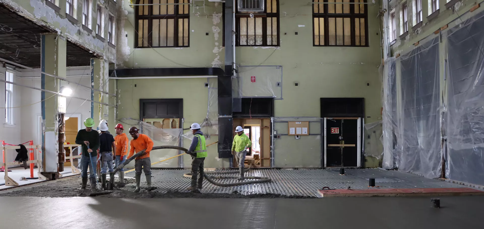 Workers putting concrete in the old stacks area of the Main Library