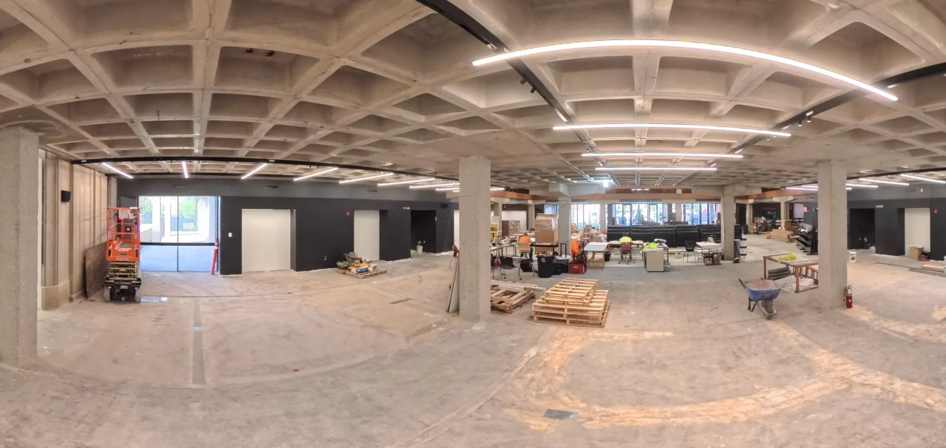 Open space with a lifter on the right and construction equipment on the left.